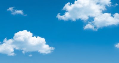 Person on hay bales in front of blue sky